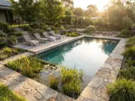 Stunning natural pool design with planted regeneration zone, natural stone edging, and eco-friendly backyard oasis landscaping