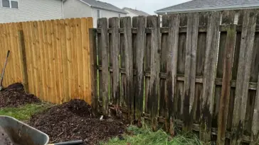 Cheap DIY wood fence rot after two seasons with rotting fence posts, warped pickets, and moisture damage in a backyard
