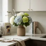 Grocery store hydrangea bouquet styled to look like a designer flower arrangement in a ceramic vase