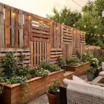Full-height pallet and reclaimed wood fencing ideas for backyard privacy with DIY rustic modern style