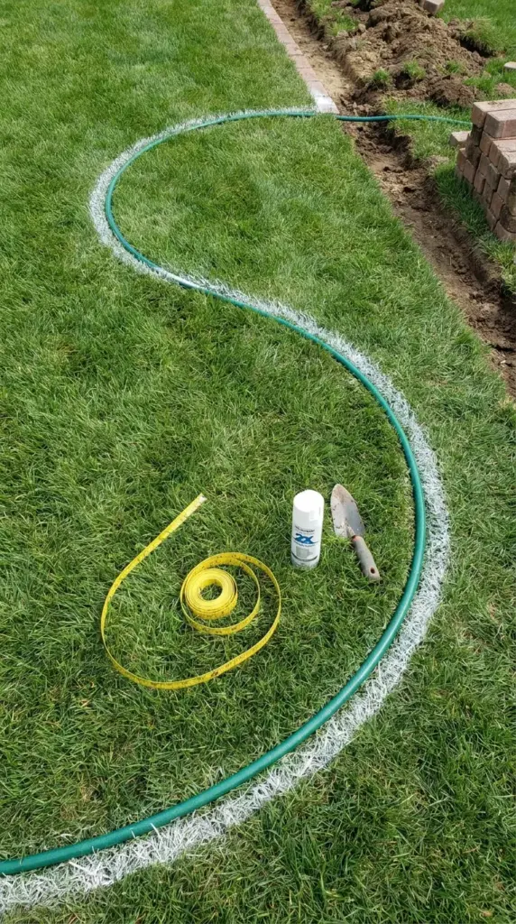 Planning a smooth natural-looking curve for brick garden edging with a hose layout