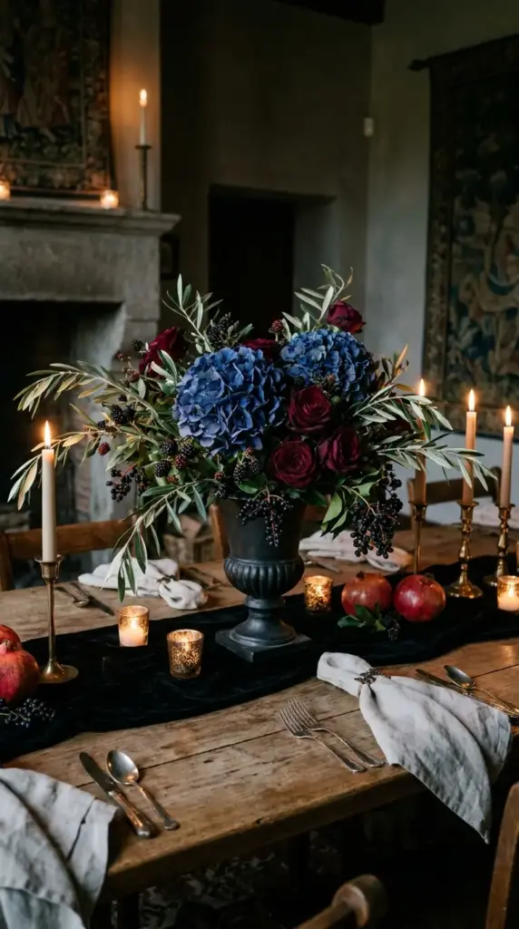 Moody hydrangea centerpiece with deep blue, olive, and burgundy flowers for dramatic fall floral design