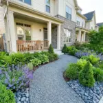 Small low-maintenance front yard landscaping with a gravel pathway and perennial flowers.