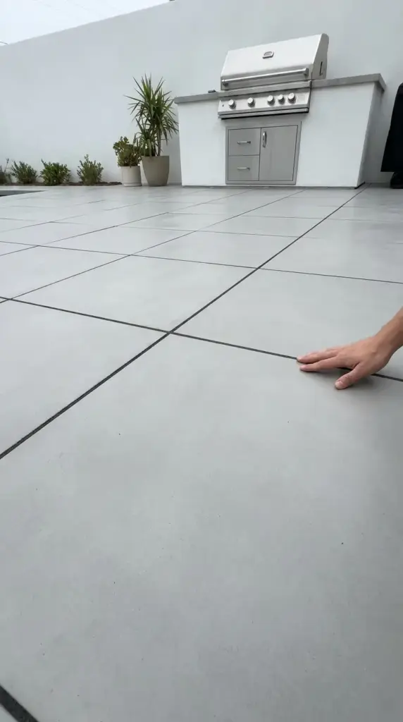 Large format pavers creating a custom faux slab patio floor without needing a contractor.