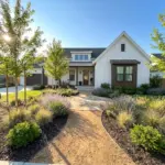 Elegant front yard landscaping design on a budget featuring a clean walkway and lush garden beds.
