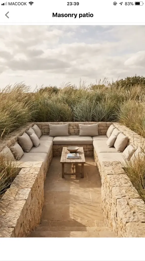 A sunken backyard patio footprint featuring short retaining walls built for wind protection and permanent extra built-in seating.