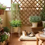 A calico cat relaxing peacefully in a cat-friendly small balcony garden with elevated modern planters and lush green trailing vines.