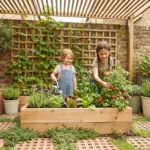 Happy children actively gardening in a compact, optimized backyard patio with a kid-height raised bed and vertical trellis.