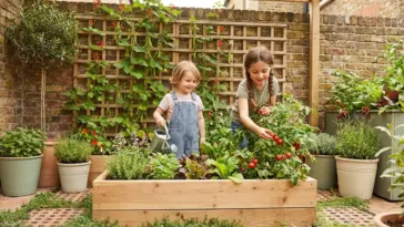 Happy children actively gardening in a compact, optimized backyard patio with a kid-height raised bed and vertical trellis.